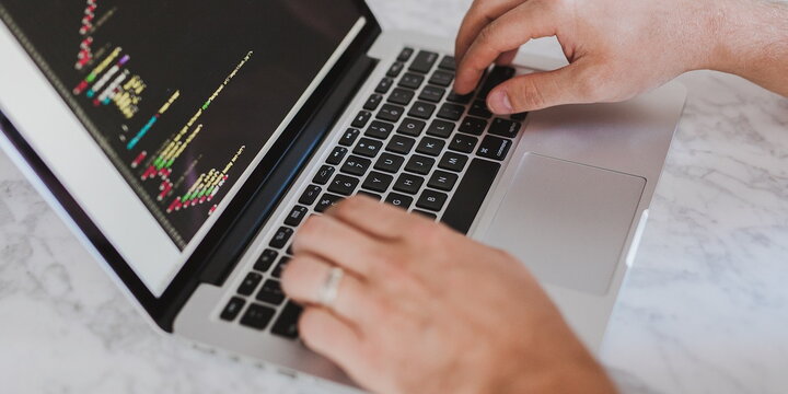 man coding on computer