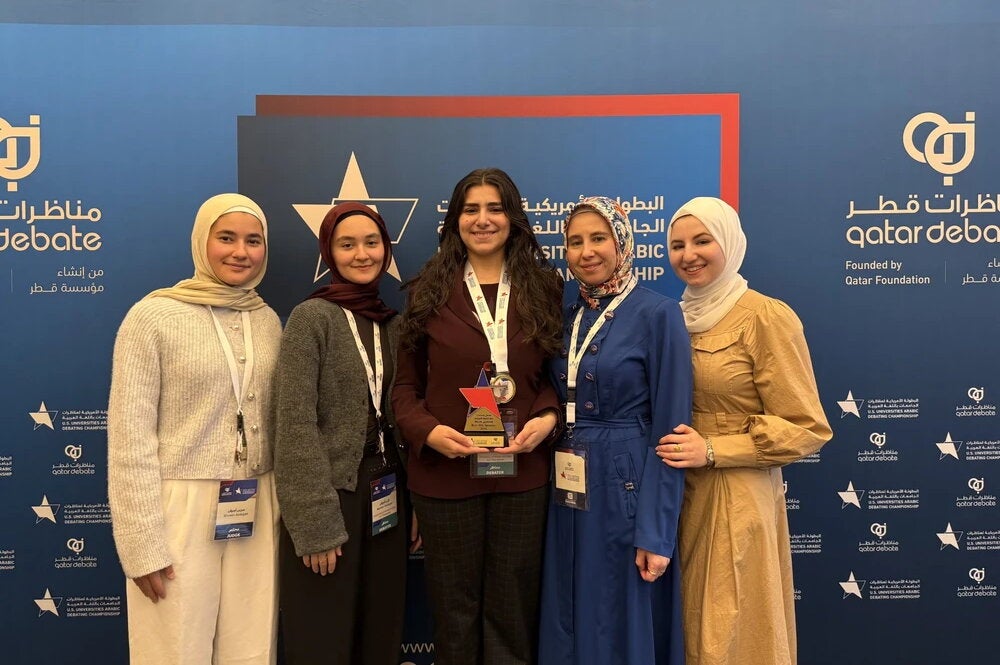 Debate Champion Foziea Garada next to her coach Dr. Eman Saadah holding her first place award at the U.S. Arabic Debate Championship