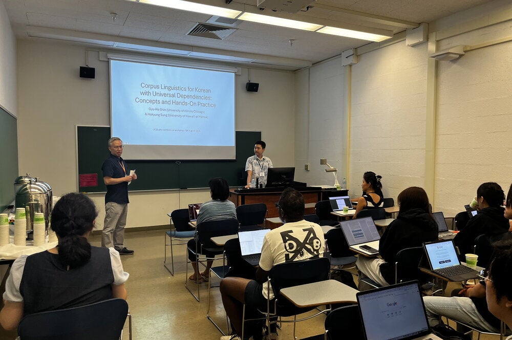 A classroom engaged in learning using laptops at the conference workshop