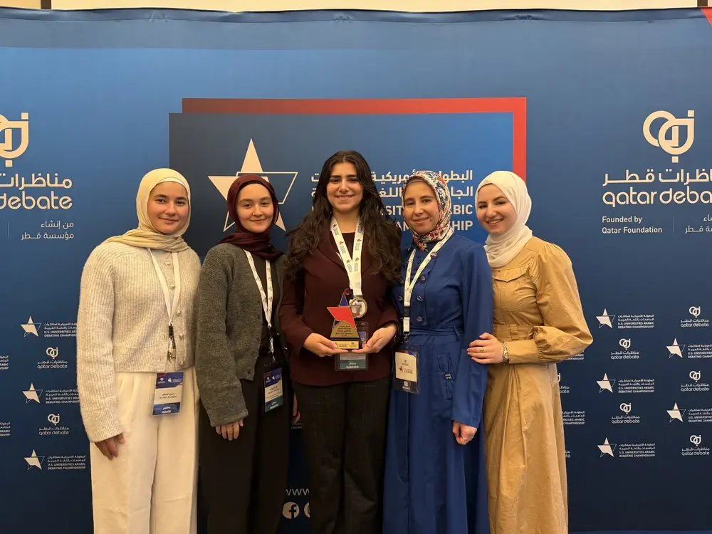Debate Champion Foziea Garada next to her coach Dr. Eman Saadah holding her first place award at the U.S. Arabic Debate Championship