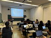 A classroom engaged in learning using laptops at the conference workshop